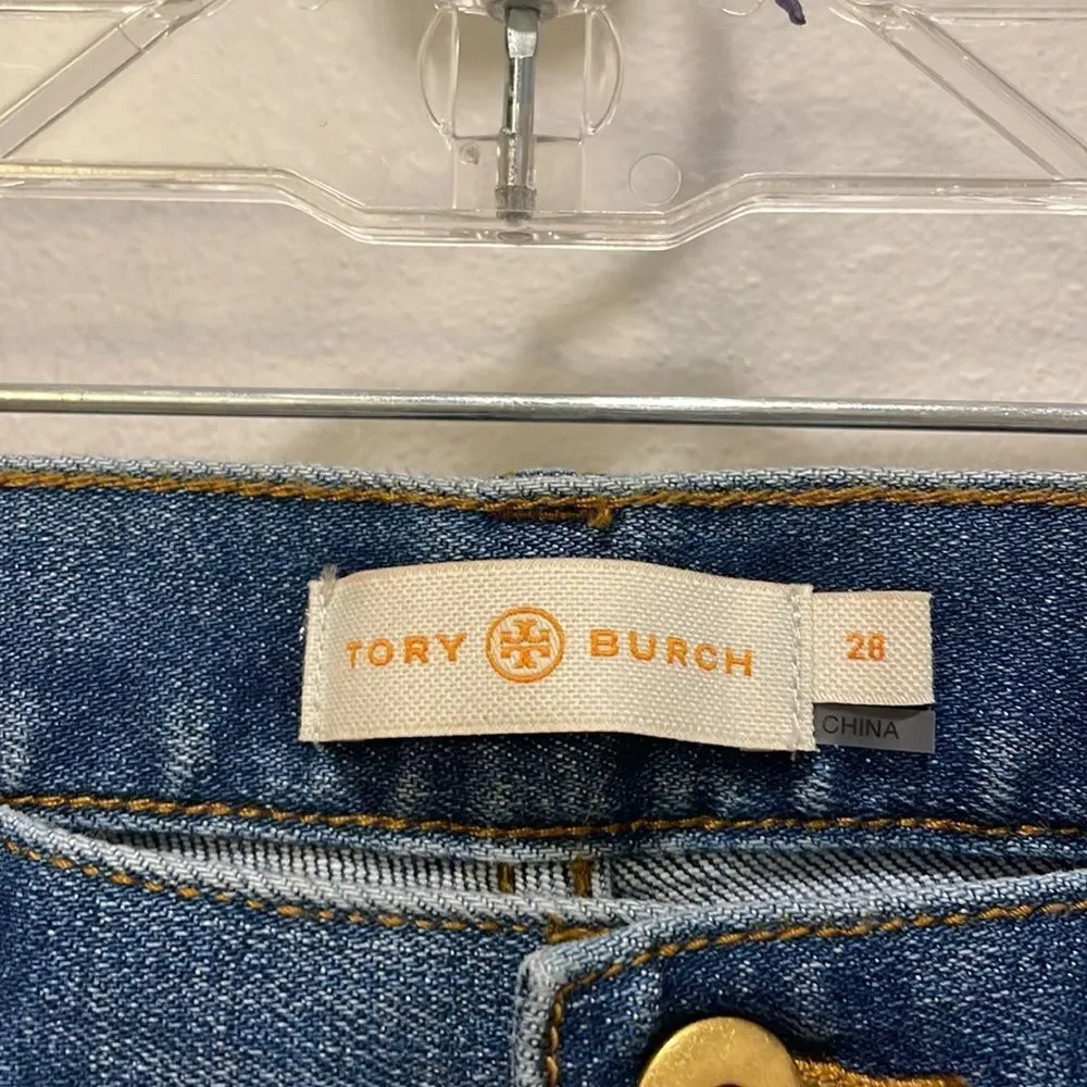 Tory Burch Connor jeans in medium allover stone wash. Cropped. Raffia fringed